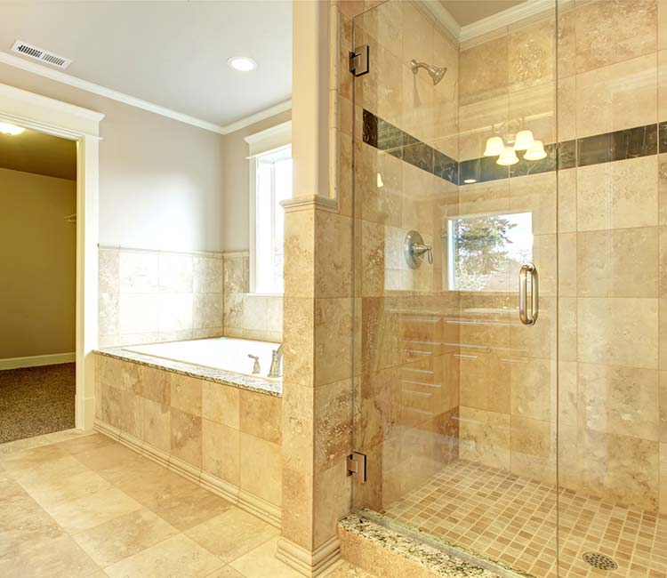 Luxurious bathroom with a glass shower and tiled walls, representing bath remodeling in Cave Spring