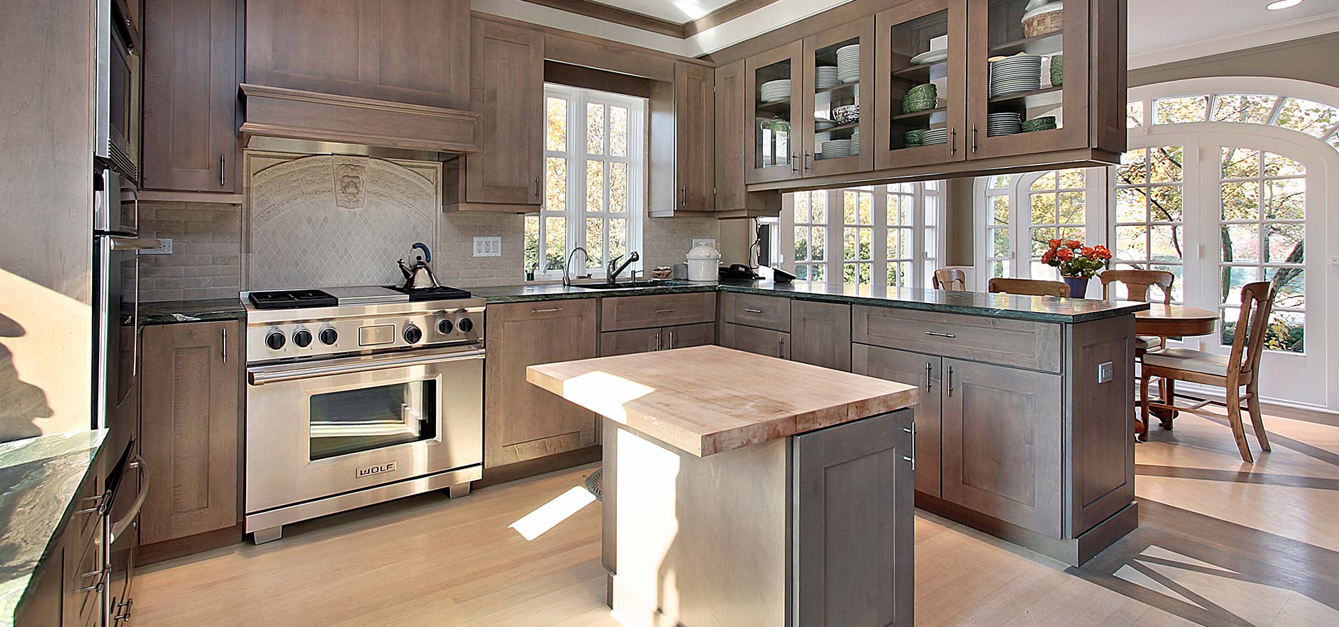 Rustic kitchen with wooden cabinets and a central island, highlighting kitchen remodeling in Cave Spring by MJ Painting & Renovations