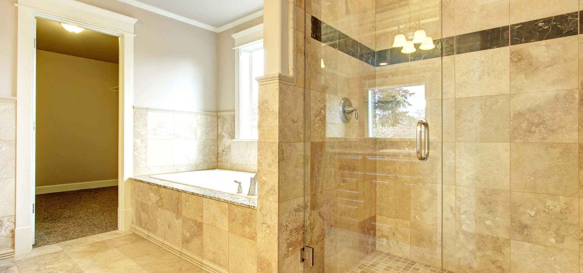 Luxurious bathroom with a glass shower and tiled walls, representing bath remodeling in Cave Spring