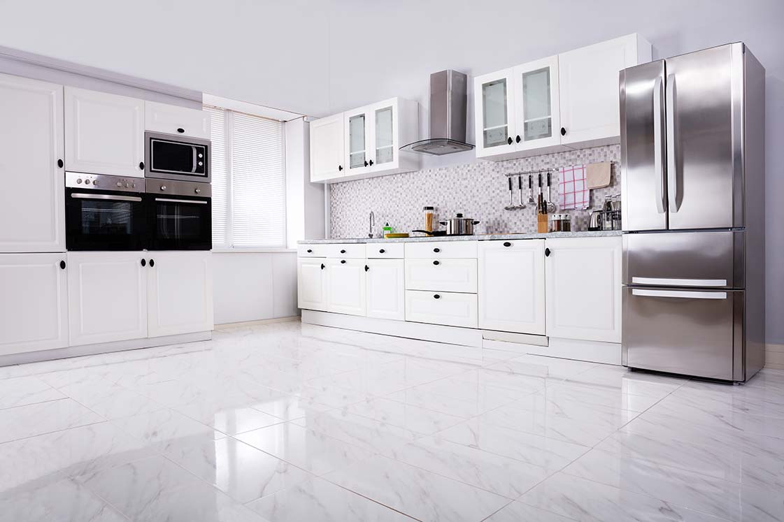 Contemporary white kitchen with marble flooring and stainless steel refrigerator, designed for home improvement in Cave Spring