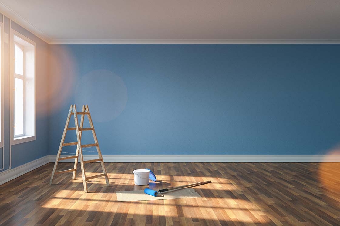 Room with blue painted walls and wooden flooring, prepared for painting, showcasing interior painting in Cave Spring