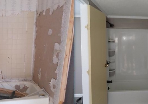 A bathroom with a door and a bathtub, showcasing bath remodeling services in Cave Spring